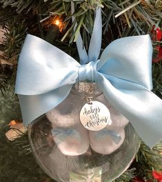 a glass ornament with baby's first christmas ornaments