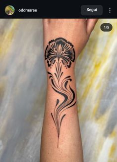 a woman's arm with a black flower tattoo on it and the words, oddamare