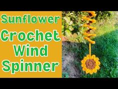 the sunflower crochet wind spinner is shown in front of grass and flowers