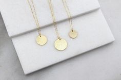 "Simple Disc Necklace This classic design is hammered by hand for an elegant finish. Perfect for layering or everyday wear! D E T A I L S -Your choice of disc in 13mm, 16mm or 19mm -A high quality delicate link chain -Hammered by hand for an elegant finish -Disc and necklace are 14kt Gold-Filled or Sterling Silver - not plated LENGTH - Please select from the drop down selection. - The standard length is normally 18\". - Model is wearing the 13mm disc at 16\" and the 19mm disc at 20\" in Photo 4. 14k Gold Hammered Necklace For Wedding, Hammered 14k Gold Wedding Necklace, Wedding Hammered 14k Gold Necklaces, Delicate Hammered Jewelry For Everyday, Delicate Everyday Hammered Jewelry, Minimalist Round Brass Charm Necklace, Simple Adjustable Hammered Jewelry, Dainty Hammered Jewelry For Everyday, Minimalist Personalized Brass Necklaces