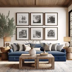 a living room with blue couches and pictures on the wall above them in black and white