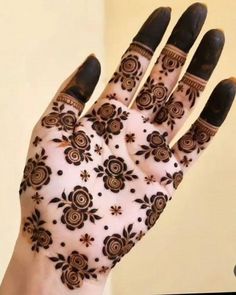 a woman's hand with henna on it