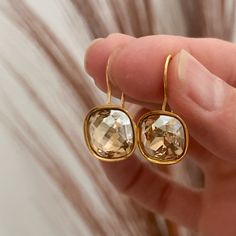 Adorable, handmade champagne diamond cushion cut / square Swarovski crystal earrings in golden shadow with a gold plated drop ear wire.   These are the perfect rhinestone bridesmaids earrings - and all Sela + Sage jewelry comes in matte black gift boxes, making the perfect bridesmaids gift! This design is also available in silver: https://www.etsy.com/listing/179648850/cushion-cut-silver-swarovski-crystal Sela+Sage is a hand crafted jewelry line with all pieces designed and made in Lake Oswego, Sage Jewelry, Square Crystal Earrings, Bridesmaids Earrings, Pretty Jewelry Necklaces, Golden Shadow, Square Crystal, Lake Oswego, Swarovski Crystal Earrings, Champagne Diamond