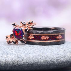 two rings with different designs on them sitting on top of a rock next to each other