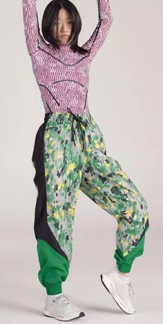 Show your summer colors in the vibrant and colorful adidas by Stella McCartney Printed Woven Track Pants. Mixing floral-inspired prints with graphic color-blocked inserts, these track pants are sure to make a statement. Made from 100% recycled polyester, these track pants are a testament to our effort to end plastic waste. You can leave the house with your small essentials thanks to the pockets, and the waistband is easily adjusted with a drawcord. Wear the loose-fitting track pants on your way to the studio and keep them on to brunch after. This product is a pair of green woven track pants from the collaboration between Stella McCartney and Adidas. The pants feature a colorful print, drawstring closure, and are made of polyester. They are designed for women in a regular fit and size mediu Colorful Adidas, Adidas Collaboration, Adidas Stella, Adidas Stella Mccartney, Pants Green, Adidas By Stella Mccartney, Active Wear Pants, Stella Mccartney Adidas, Plastic Waste