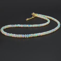 Natural Ethiopian Opal Beads Necklace, White Opal Jewelry, Rainbow Fire Opal Gemstone Necklace for Women, Opal Beaded Jewelry, Birthday Gift Product Detail:- Gemstone - Ethiopian Opal  Beads Size - 4 to 6 MM Beads Color - Natural White Type - Faceted Opal Beads Quality - Top Rare Quality  Fire - Multi Rainbow Fire Origin - Ethiopian Welo   Shipping Service - Free World Wide Shipping Service These Handmade Opal Beaded Jewelry are unique and exclusive to Aimstones shop. You will not find them anyw Opal Gemstone Beaded Rondelle Necklace, Opal Rondelle Necklace With Gemstone Beads, Opal Rondelle Bead Necklace, Polished Round Bead Opal Necklaces, Polished Round Opal Bead Necklaces, Opal Beaded Necklaces With Round Beads, Opal Necklaces With Polished Round Beads, Beaded Opal Rondelle Necklaces, Gemstone Necklace With Ethiopian Opal Round Beads