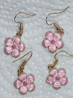 These sweet pink flower charms are edged in gold, the center is a sparkly faceted pink crystal rhinestone.  Tge base is gold tone.  Beautifully detailed, these are lightweight, delicate little earrings.  suitable for younger girls.  I added nickel free gold tone ear wires. All  materials used are nickel free. Please feel free to reach out with any questions. I ship daily Mon-Fri except holiday, with tracking in USA only  PLEASE NOTE: local regulations do not allow returns or exchanges of pierced jewelry. Cute Gold Flower-shaped Earrings, Cute Rose Gold Flower Jewelry, Cute Rose Gold Flower-shaped Jewelry, Pink Flower Charm Dangle Jewelry, Cute Gold Flower Earrings For Spring, Cute Rose Gold Jewelry With Flower Charm, Dainty Pink Flower-shaped Earrings, Dainty Pink Flower Earrings, Pink Gold Flower Earrings As Gift