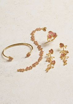 Featuring 18k gold dipped brass accented with hand set crystals, the sculpts of the earrings are as delicate as they are intricate. The stems each have multiple hinges, allowing the crystal pavé flowers in a combination of fuchsia and pale pink crystal to swing and catch the light beautifully. 18K Gold Plated Brass Crystal 2.2" H x 0.8" W