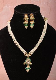 Ahmedabad, Gujarat is well known for its fine Kundan Jewelry art that has been practiced for centuries. Inspired by Royal designs, with a dash of contemporary this set with white multi strand white beads befits a queen! The central Drop pendant with dangling Beads and earrings are prominent and charming  Note: This jewelry has no precious metals or stones. Note: Some pics are close up shots to show detail and may make the product appear larger. For a more accurate perspective on size, please check the measurements picture. Luxury Handmade Kundan Temple Necklace, Luxury Kundan Meenakari Temple Necklace, Luxury Handmade Kundan Temple Jewelry Necklace, Traditional White Kundan Necklace With Dangling Beads, Handmade White Fusion Jewelry, Traditional White Beaded Necklace For Gift, Handmade White Kundan Necklace With Round Beads, Festive White Kundan Necklace With Dangling Beads, Handmade White Temple Jewelry Necklaces