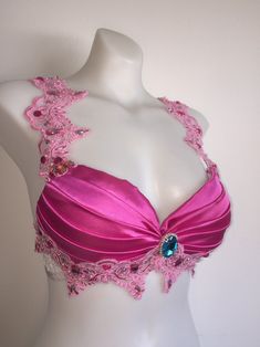 a mannequin wearing a pink bra with beaded trim