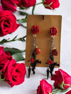 Perfect for any gothic beauty, these dangle earings feature a rose wrapped crucifix, a spike and a skull. Large roses on earring backing and the skulls can be changed to black instead of red. Those are the only colors that can be altered. Large Roses, Gothic Rose, Gothic Beauty, Etsy Earrings Dangle, Colorado Springs, Earring Backs, Beautiful Jewelry, Jewelry Earrings Dangle, Dangle Drop Earrings