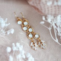 "Boho Wedding Earrings // Bridal Statement Earrings // 14k Gold Filled Earrings Gorgeous glowing opalite stones and dainty cubic zirconia fans secured to delicate 14k gold filled earring wires. These long and beautiful statement earrings are the perfect accessory for your special day or your bridesmaids. All of my jewelry arrives suitably gift wrapped ready for gift giving. For hygienic reasons I don't accept returns or exchanges on earrings. Measurements: The bridal statement earrings hang appr White Plated Drop Earrings, Gold Cluster Earrings For Celebrations, Gold Plated Round Clip-on Earrings For Wedding, Gold Plated Pierced Jewelry For Wedding, Dangle Cluster Earrings For Wedding, Gold Plated Drop Clip-on Earrings For Wedding, Gold Plated Clip-on Drop Earrings For Wedding, Pierced Yellow Gold Crystal Earrings For Weddings, Delicate Jewelry With Matching Earrings For Celebration