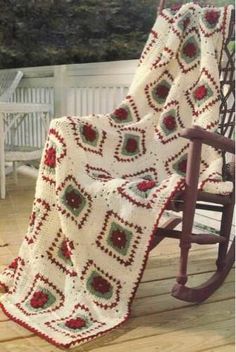 a rocking chair with a crocheted blanket on it