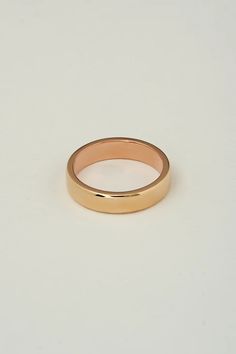 Our most popular mens band. The two tone band is composed of a 14k yellow gold exterior, with a 14k rose gold interior in a slight comfort fit. When worn the band has a slight glistening rim of rose gold on the edge.  We prefer this band in a 5mm - 6mm width for a skinnier more comfortable fit.  Hammered exterior textu Classic Rose Gold Wedding Ring With Decorative Band, Classic Pink Gold Ring, Classic Wide Band Rose Gold Ring With Polished Finish, Classic 14k Rose Gold Wide Band Ring, Classic Rose Gold Wide Band Ring With Polished Finish, Classic Rose Gold 14k Wide Band Ring, Yellow Gold Thick Band Ring, Rose Gold Polished Finish Band For Promise Ring, Rose Gold Bands With Polished Finish For Promise Ring