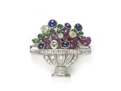 A Jardiniére brooch, mounted in platinum, with a diamond bowl set with round brilliant and baguette-cut diamonds, with carved rubies and cabochon-cut sapphires and emeralds depicting the flowers. Period: Circa 1960 Style: Vintage Metal: Platinum Stone: Sapphire, ruby, emerald and diamond Condition: Good - Wear consistent with age and use White Gold Drop Earrings, Gem Diamonds, Yellow Gemstones, Ruby Sapphire, Pearl Brooch, Art Deco Diamond, Ruby Diamond, Gold Drop Earrings, Vintage Diamond