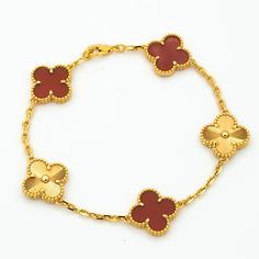 This charming Clover Bracelet showcases 5 stunning motifs in Carnelian Gold. The delicate design exudes elegance and sophistication, making it the perfect accessory for any occasion. Show off your style with this unique and versatile bracelet that effortlessly elevates any outfit. ADDITIONAL INFORMATION Color: Gold Stone:no Ref. H1213121 Material:- 925 Sterling Silver - 18k Gold Plated- 18k Real Gold ( contact us via instagram) Bracelet wrist size: 19 cm Our replica products are committed to qua Cheap Elegant Yellow Gold Charm Bracelet, Luxury Gold Bracelet For Anniversary, Luxury Yellow Gold Jewelry, Luxury Yellow Gold Bracelet, Luxury White Gold Bracelet, Luxury White Gold Chain Bracelet, Luxury Yellow Gold Cuff Bracelet, Luxury Red Round Gold Bracelet, Luxury Gold Bracelet With Polished Finish