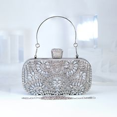 New to our Millennium collection, This beautiful romantic Silver Crystal Floral Leaves bridal clutch bag is made of very fine quality of crystal,  rhinestones, fabric and metal and it comes with Chain 46 inches long os cross body bag Detachable chain for your Big day! The Clutch measure about 7.5 inches long, 4 inches wide and thickness of the bag is 1.8 inches  ► ABOUT YOUR ORDER * All items are neatly packaged in our beautiful jewelry boxes and elegant organza bags. * All items are 100% gift-r Elegant Handheld Bags For Wedding Guest, Elegant Handheld Bag For Wedding Guest, Elegant Party Pouch With Detachable Handle, Elegant Rectangular Pouch With Detachable Handle, Silver Pouch Evening Bag For Events, Elegant Evening Pouch With Detachable Handle, Elegant Wedding Pouch Box Bag, Silver Handheld Box Bag For Evening, Elegant Pouch Box Bag For Wedding