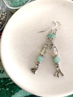 Aqumarine and silver, these dainty handcrafted earrings can be customised with your choice from the four gorgeous styles.  Created with bohemian vibes these are a one of a kind artisan made accessory. With amazing light blue glass, solid sterling silver ear wires combined with high-quality nickel free silver beads and charms, these earrings are perfect for special occasion or everyday wear. These beauties will shine as sister or bridesmaid gifts for 2,3 or 4 special people and are the perfect ad Handmade Elegant Aquamarine Earrings, Elegant Aquamarine Nickel-free Earrings, Handmade Aquamarine Drop Earrings, Silver Aquamarine Earrings For Wedding, Handmade Turquoise Aquamarine Earrings, Silver Aquamarine Jewelry Set With Earrings, Czech Glass Dangle Earrings For Wedding, Silver Aquamarine Dangle Earrings, Wedding Czech Glass Dangle Earrings