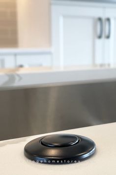 close up image of matte black disposal button installed in white marble look quartz countertop Garbage Disposal Button, Calacatta Laza Quartz, Calacatta Laza, Black Kitchen Design, Kitchen Garbage, Island Counter, Countertops Granite, Matte Black Kitchen, Home Stores