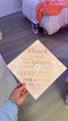 a person holding up a graduation cap that says, he is his plan to her