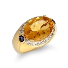 A 15x10mm bright canary citrine surrounded by diamonds and flanked by two small amethysts in 14kt yellow gold. Classic Rings With Oval Cabochon Gemstone Accents, Oval Yellow Gold Sapphire Ring, Formal Oval Cabochon Topaz Ring, Classic Yellow Gold Topaz Ring With Gemstone Accents, Oval Amethyst Ring In Yellow Gold With Polished Finish, Classic Oval Yellow Gold Gemstone, Oval Yellow Gold Sapphire Ring With Gemstone, Oval Yellow Gold Amethyst Ring With Polished Finish, Oval Yellow Gold Topaz Ring With Center Stone