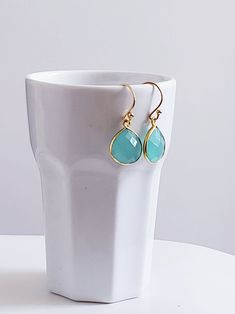 Lightweight and charming, these delicate green Chalcedony Earrings feature faceted pear-shaped drops in softly translucent deep aqua hues. The gemstones are set in 18k gold over sterling silver (Vermeil.) Very pretty and perfect for work or to wear with your hair up. Drops measure 1/2 inch. Handmade in IndiaDesigned in New York © All artwork, jewelry designs, and digital images are the property of Summer Indigo and may not be copied or reproduced without permission. Turquoise Teardrop Faceted Earrings, Turquoise Faceted Teardrop Earrings, Faceted Turquoise Teardrop Earrings, Faceted Drop Teardrop Earrings For Gift, Green Faceted Teardrop Earrings, Elegant Turquoise Drop Teardrop Earrings, Turquoise Briolette Earrings As A Gift, Turquoise Briolette Earrings For Gift, Faceted Pear-shaped Earrings For Gift