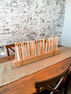 many candles are lit on a wooden stand