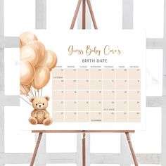 a baby shower calendar with a teddy bear holding balloons on it's back and the date in gold