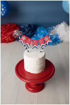 a white cake with red and blue decorations