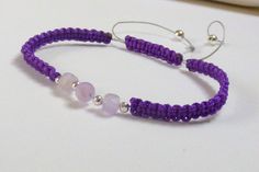 Genuine Amethyst Macrame Bracelet. I have made this Macrame Bracelet with Purple Cord,  and 3 Genuine Lavender  Amethyst Cubes .  And Sterling Silver Accent Beads  Amethyst is The Birthstone for February. Lovely worn alone or stacked with multiple Bracelet. This Bracelet is 7 inches ,  but if you would like another size just let me know. Your Bracelet will arrive wrapped in tissue and placed in a gift bag,  ready for gift giving or treating yourself. Please feel free to contact me with any quest Handmade Adjustable Purple Bracelets, Handmade Adjustable Purple Bracelet, Bohemian Purple Resizable Bracelets, Purple Beaded Bracelets With Sliding Knot As Gift, Purple Bohemian Bracelet With Adjustable Cord, Gift Purple Beaded Bracelets With Sliding Knot, Bohemian Purple Bracelet With Adjustable Cord, Adjustable Purple Beaded Bracelets With Sliding Knot, Adjustable Amethyst Beaded Bracelet