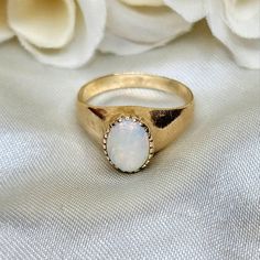 "Beautiful vintage ladies' ring circa 1960's. Signet style hand wrought ring in 10k yellow gold featuring a beautiful prong set Opal cabochon. Size 6 US. Weighs 3g. Stamped \"10k\" on the inside of the band along with the letter \"M\" (owner's monogram). Some very minor surface marks on the gold that could be buffed out. In overall excellent vintage condition!" Vintage 14k Stamped Opal Ring For Formal Occasions, Vintage Gold Signet Ring With Gemstone, 14k Gold Oval Cabochon Gemstone Signet Ring, Vintage Yellow Gold Signet Ring With Gemstone, Classic 14k Gold Signet Ring With Cabochon, Classic Yellow Gold Signet Ring With Cabochon, Vintage Signet Ring With Cabochon For Anniversary, 14k Gold Domed Signet Ring With Gemstone, Classic Opal Birthstone Ring As Gift