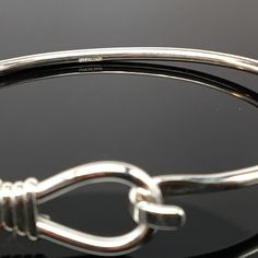 "This sterling silver Lasso Bangle is available in two finishes, sterling silver and sterling silver with 14k gold vermeil. The bangle accommodates medium and large spacer beads and traditional charms. \"Sterling\" is inscribed on the inside of the band. Brand new condition. Made by Brown County Silver. Comes in small, medium, and large sizes. Small - 6.5\" Medium - 7.25\" Large - 8\" Approximate weight is 9.7 grams See more @ https://www.etsy.com/shop/brocosi" Classic Bracelet With Sterling Silver Clasp As Gift, Adjustable White Gold Bangle With Sterling Silver Clasp, Classic Adjustable Hoop Bracelets, Sterling Silver Bangle With Lobster Clasp, Adjustable White Gold Bracelet With Lobster Clasp, Sterling Silver Clasp Bangle Bracelet, Sterling Silver Clasp Bangle For Gift, Adjustable Sterling Silver Bangle, Nickel Free Sterling Silver Classic Bangle