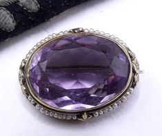 "Antique Victorian marked 14k gold and large oval shaped amethyst with mini seed pearl brooch, In good antique condition. The stone no chips. Circa 1890's. It's 1\" 1/4 long 15/16\" wide and ¼\" thick., Amethyst 20 mm x 27 mm Weighs 11 gram. Thanks." Antique Oval Amethyst Ring Collectible, Victorian Amethyst Round Jewelry, Victorian Oval Brooch, Elegant Gold Amethyst Brooches, Vintage Purple Oval Brooch, Pearl Brooch, Amethyst Jewelry, Seed Pearl, Oval Shape