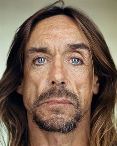 a man with long hair and blue eyes