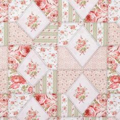 an old quilt with pink flowers on it