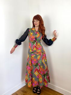 Vintage 70s maxi dress with drop waist, collar and crazy psychadelic multi-color print with black transparent sleeves. Shown here on a size FR 36/UK 8/US 2/ S model with a 172cm / 5'8" height with no adjustments and it fits with room. This dress would best fit a FR 36-38 / UK 8-10 / S-M but please verify all measurements to be sure.  Shoulder to Shoulder: 38cm - 15in Bust (Armpit to Armpit): 45.4cm - 18in Waist: 36.5cm - 14.25in (natural waist) Hips: 51cm - 20in (at drop waist) Sleeve Length: 62cm - 24.5in Overall Length:132cm - 52in  Condition: Very good  Material: no tags, but it feels like synthetic, fully lined with synthetic Closure/Details: pulls over the head and then there are buttons up the front Accessories not included but in other listings. Can't find them? Send me a message! N Transparent Sleeves, 70s Maxi Dress, Color Print, Drop Waist, Dress Clothes For Women, S Models, Vintage 70s, First Look, Colorful Prints