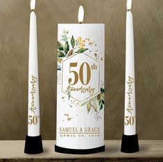 two candles with 50th anniversary stickers on them