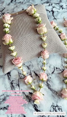 pink roses are attached to a pillow on a marble counter top with text overlay