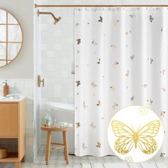 a white shower curtain with a gold butterfly on it