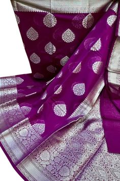 Purple saree blouse , Semi georgette saree with blouse ,  saree with border , FREE SHIPPING This is a handwoven banarasi  semi  georgette   saree in  beautiful  purple   color . The saree  comes with zari butis all over the body ,  zari borders on both the sides  and with a heavy pallu .  The saree comes with  an unstitched blouse piece .  MATERIAL   : Banarasi   Semi -  Georgette  MEASUREMENTS : Width of the Saree :  44  Inches  Length of the Saree :  5.50 meters  Matching  Blouse Piece -  90 cms  PLEASE NOTE : Since this is a completely handmade product , there might be some minor imperfections but these imperfections reflect the handmade qualities of the product .  Due to different monitor settings , some colors may seem slightly different on your screen . SHIPPING : For Normal Standard Purple Saree Blouse, Saree With Border, Saree Bluse, Georgette Saree With Blouse, Purple Saree, Blouse Saree, Georgette Saree, Saree With Blouse, Georgette Sarees