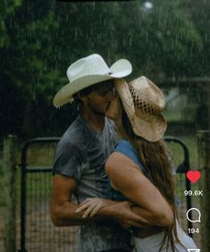 a man and woman kissing in the rain with an instagram button on their phone