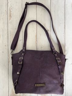 Simple lines create a striking design for this bag, with the perfect amount of slouch to be the perfect school, work or casual bag. This is my own everyday go-to bag (well not this exact one, but same style), so I might be biased! I never make exactly the same bag twice, so this is really one of a kind. The purple example bag shown is made of vegan leather with complementary black nickel metallic hardware. The lining is a Kaffe Fassett designer fabric in a gorgeous grey and lilac floral print. Modern Purple Shoulder Bag, Trendy Satchel Weekender Bag For Everyday Use, Modern Rectangular Purple Satchel, Modern Purple Rectangular Satchel, Purple Large Capacity Double Handle Satchel, Modern Purple Bag For Everyday Use, Modern Purple Satchel For Daily Use, Modern Purple Shoulder Bag For Everyday Use, Modern Purple Bags For Everyday Use