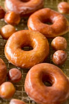 there are many glazed donuts on the cooling rack