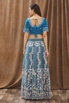 Teal blue lehenga with floral embroidered motifs. Comes with blouse and dupatta.
Components:3
Pattern:Embroidery
Type of Work:Sequin, Beads, Thread and Cutdana
Neckline:V neck
Sleeve Length:Half
Fabric:Moda Silk and Organza
Color:Blue
Other Details:
Blouse with cutwork detail
Sheer dupatta with embroidered motifs and cutwork border
Low back with tie up and tassels
Occasion:Wedding - Aza Fashions Blue Anarkali Lehenga With Intricate Embroidery, Blue Floor-length Embroidered Designer Fabric, Blue Floor-length Resham Embroidered Fabric, Fitted Blue Pre-draped Saree With Intricate Embroidery, Blue Floor-length Fabric With Resham Embroidery, Blue Festive Choli With Intricate Embroidery, Blue Embroidered Saree Set, Blue Saree Set With Intricate Embroidery, Blue Embroidered Sharara For Reception