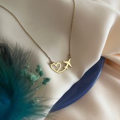 Heart and Airplane Necklace - Heart Flying Necklace - Gift for Travel Lover - Gift for Pilot - Stewardess Gift - Traveler's Necklace - Modern Jewelry - Best Friend Gift's - Valentine's Day Gift Introducing our Heart and Airplane Necklace, the perfect gift for pilots or a delightful hostess gift. This exquisite necklace combines elegance with a touch of wanderlust, making it a unique and thoughtful present for aviation enthusiasts or those who love to travel. Material - High Quality Handmade 925 Sterling Silver - 18K Gold Plated and 18K Rose Plated - High Quality Handmade 8K REAL GOLD and 14K REAL GOLD - 8K & 14K REAL ROSE GOLD and 8K & 14K REAL WHITE GOLD Preparation and Shipping : - The processing time of all our products is 3-5 working days. - You can send us a message for fast shipping Personalized Pendant Necklaces For Travel, Pilot Necklace, Pilot Jewelry, Gifts For Pilot, Aviation Jewelry, Airplane Jewelry, Necklace Photography, Bracelet Board, Airplane Necklace