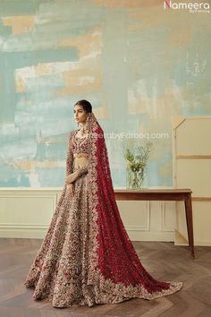 a woman in a red and gold lehenga