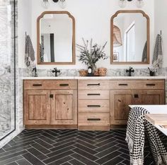 a bathroom with two sinks and mirrors in it