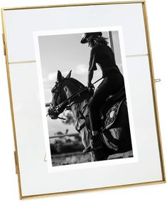 a black and white photo of a person on a horse