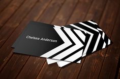 black and white business card on wooden table with wood grained flooring in the background