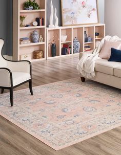 a living room filled with furniture and a large rug on top of a hard wood floor